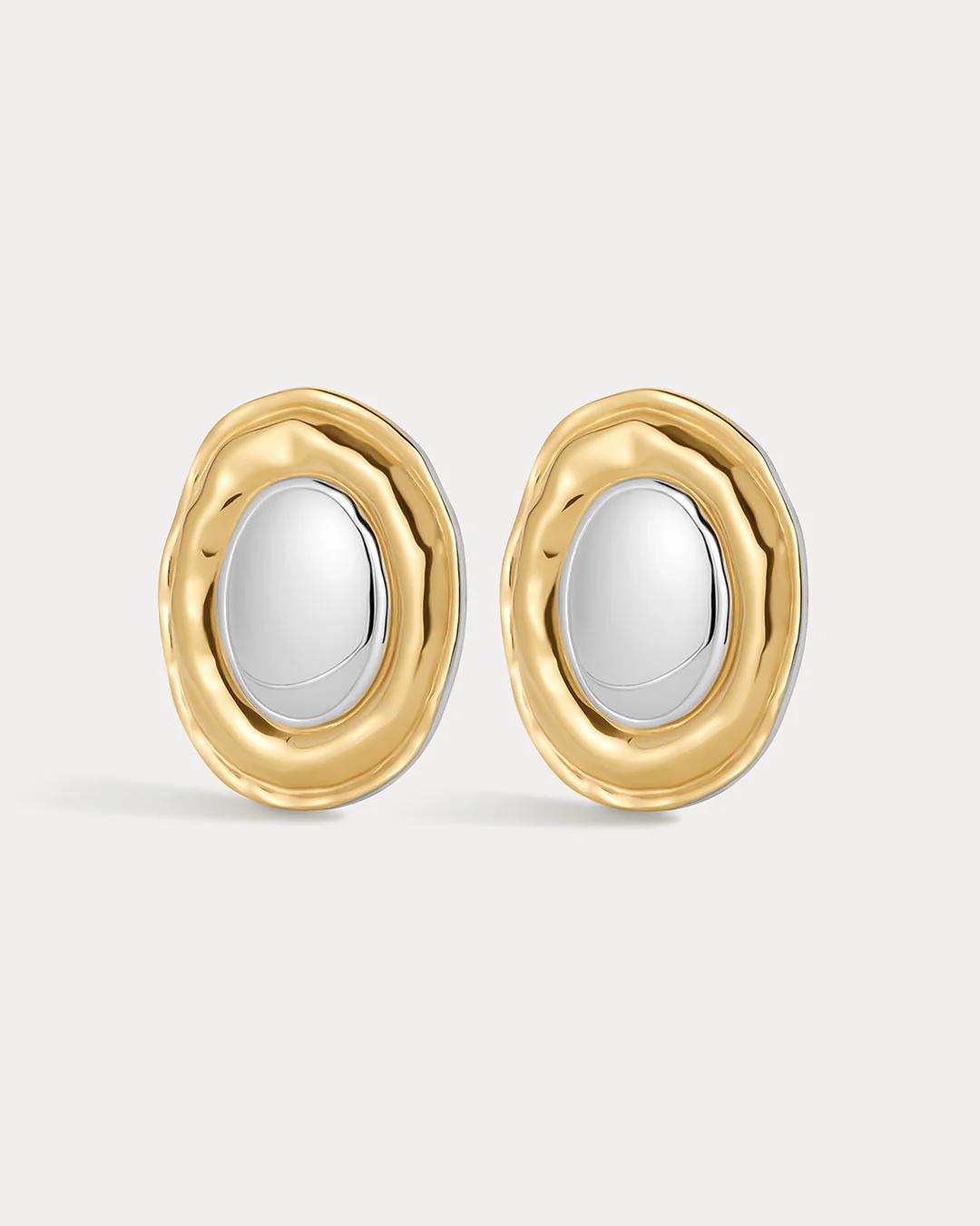 Gold and silver earrings on a light gray background