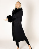 midi black coat with fur around the collar and cuffs of sleeves