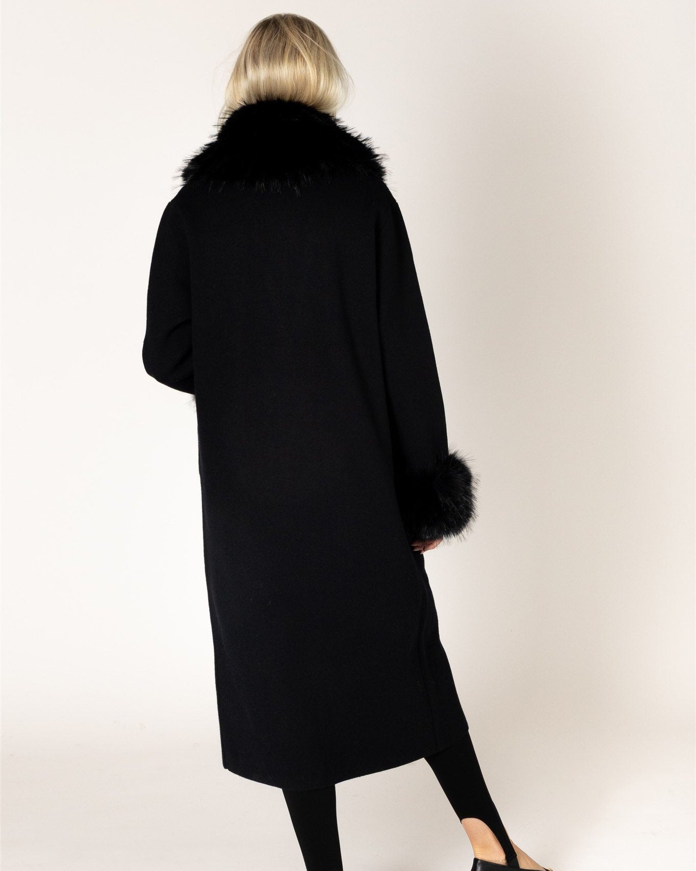 midi black coat with fur around the collar and cuffs of sleeves