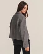 Woman wearing a gray checkered shirt