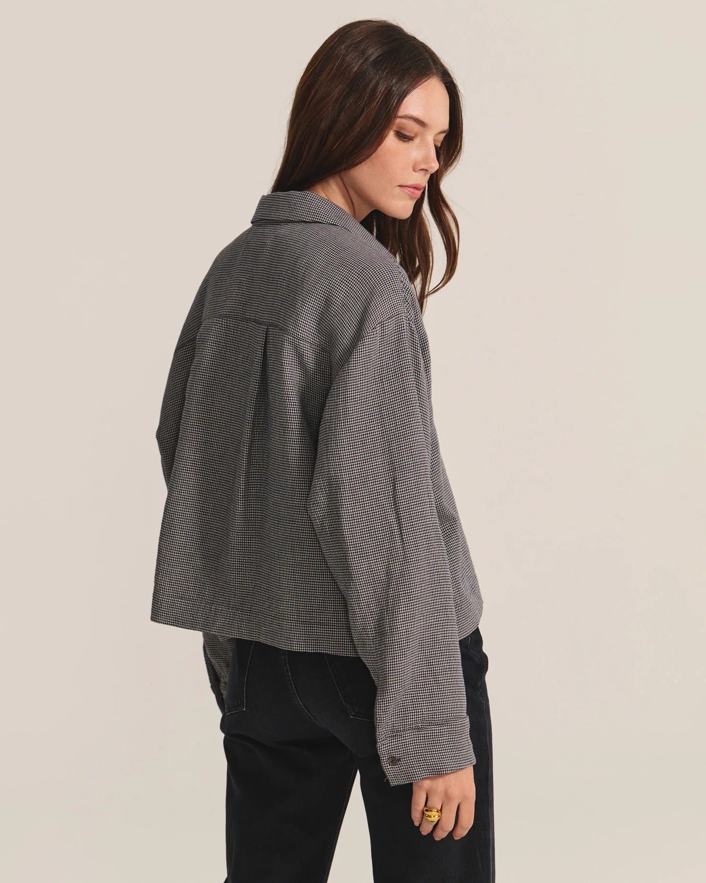 Woman wearing a gray checkered shirt