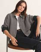 Woman wearing a gray checkered shirt