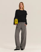 Person wearing gray wide-leg pants