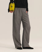 Person wearing gray wide-leg pants