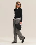 Person wearing gray wide-leg pants