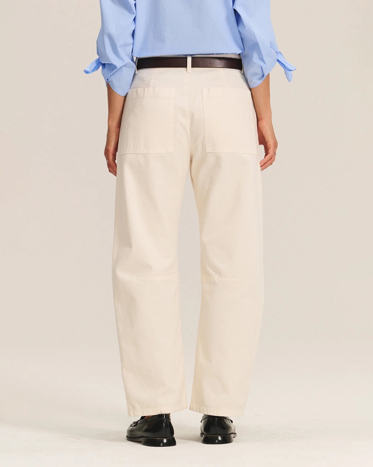 A woman wearing beige cotton pants