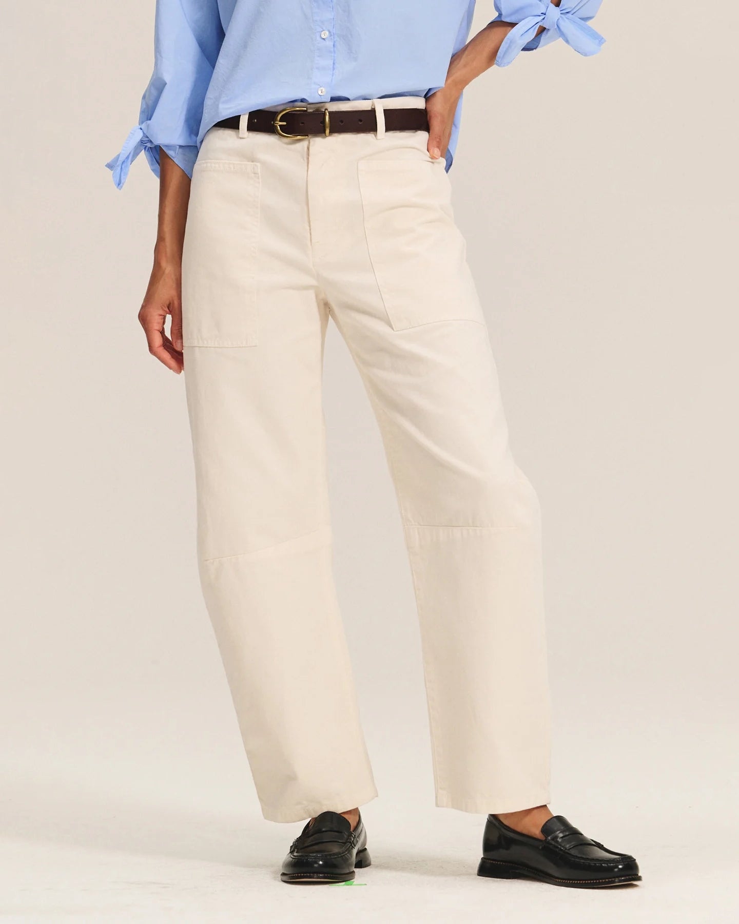 A woman wearing beige cotton pants