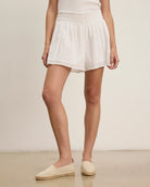 woman wearing white eyelet lace shorts 