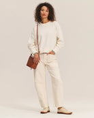 Woman wearing a cream sherpa textured sweater