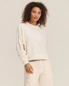 Woman wearing a cream sherpa textured sweater
