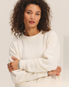 Woman wearing a cream sherpa textured sweater