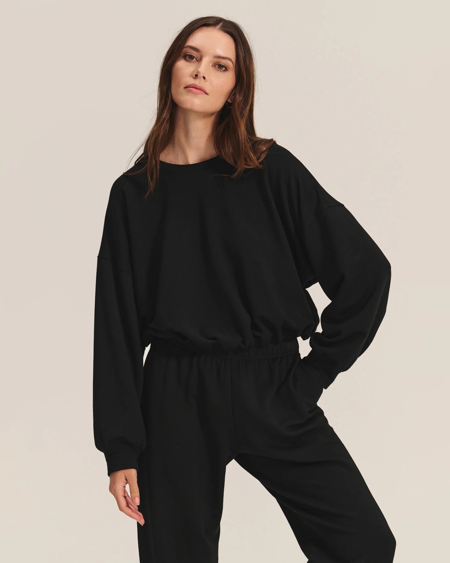 Woman wearing a black cotton sweatshirt with matching joggers