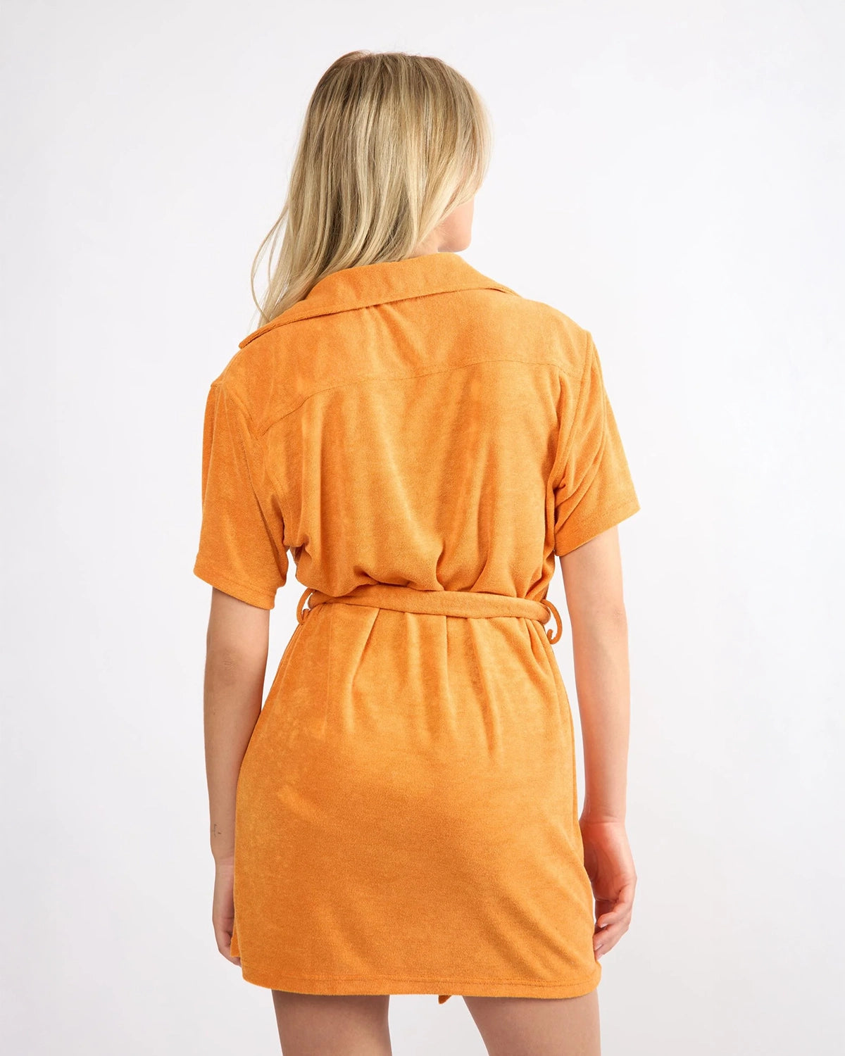 woman wearing short terry cloth cover up dress in bright orange by viens avec moi 