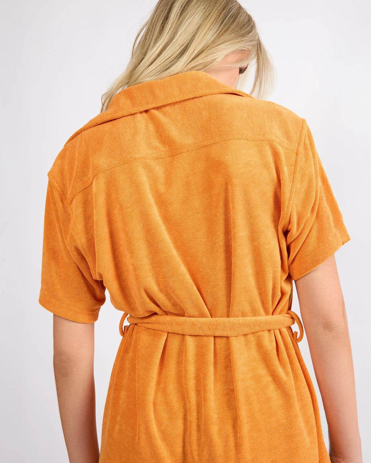 woman wearing short terry cloth cover up dress in bright orange by viens avec moi 