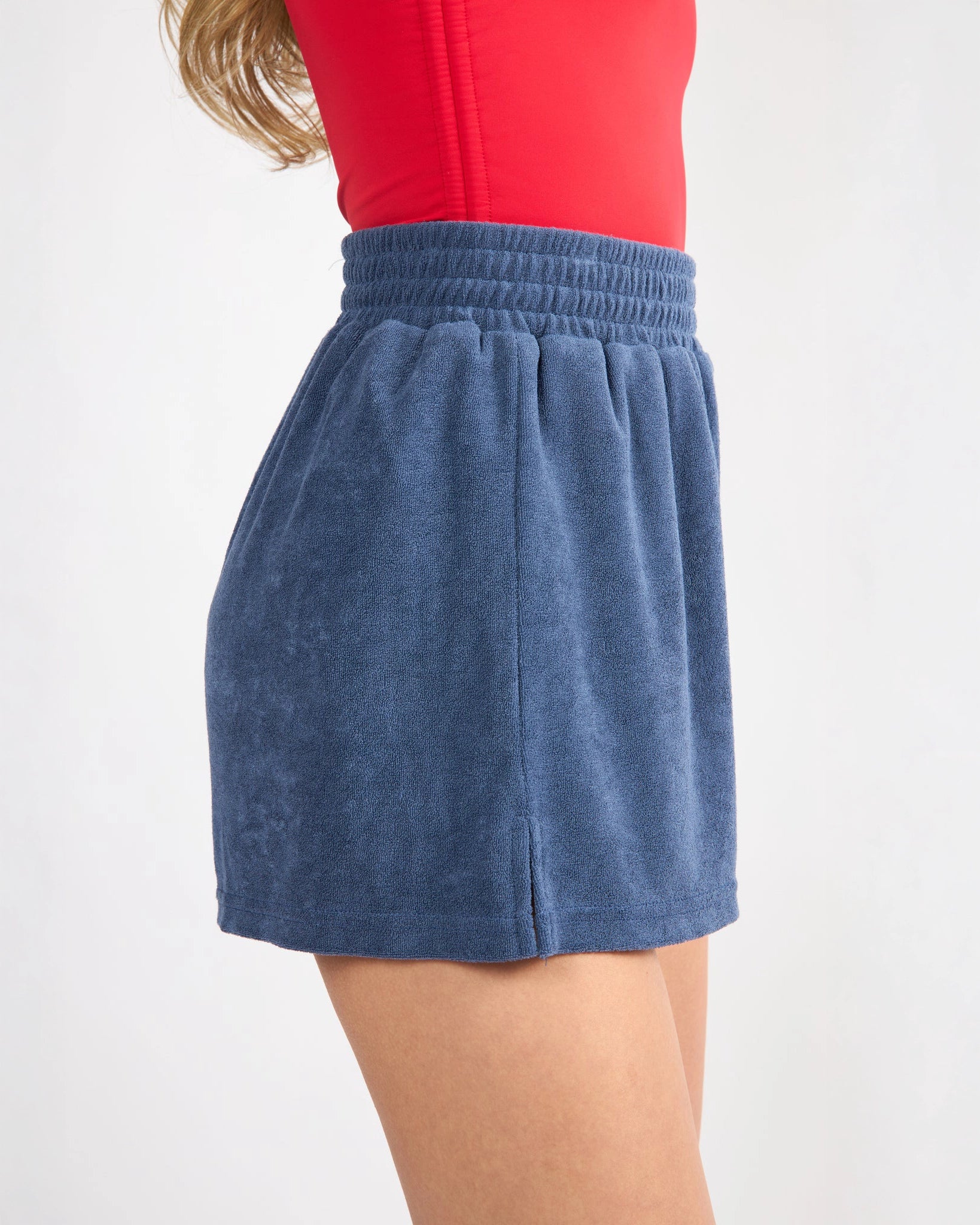 woman wearing blue terry cloth shorts 