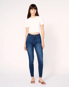 woman wearing skinny blue jeans in medium wash