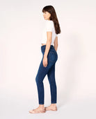 woman wearing skinny blue jeans in medium wash