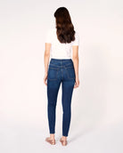 woman wearing skinny blue jeans in medium wash