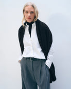 a woman wears a large cashmere wrap scarf in black