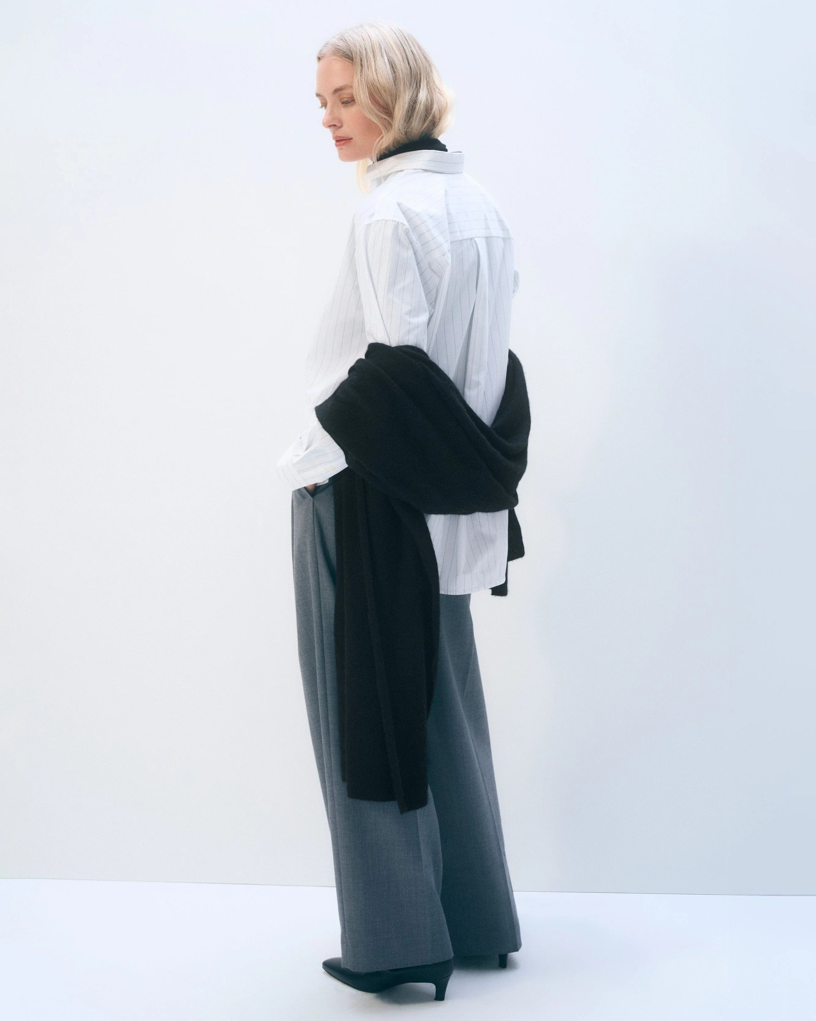 a woman wears a large cashmere wrap scarf in black