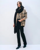 a woman wears a large cashmere wrap scarf in black