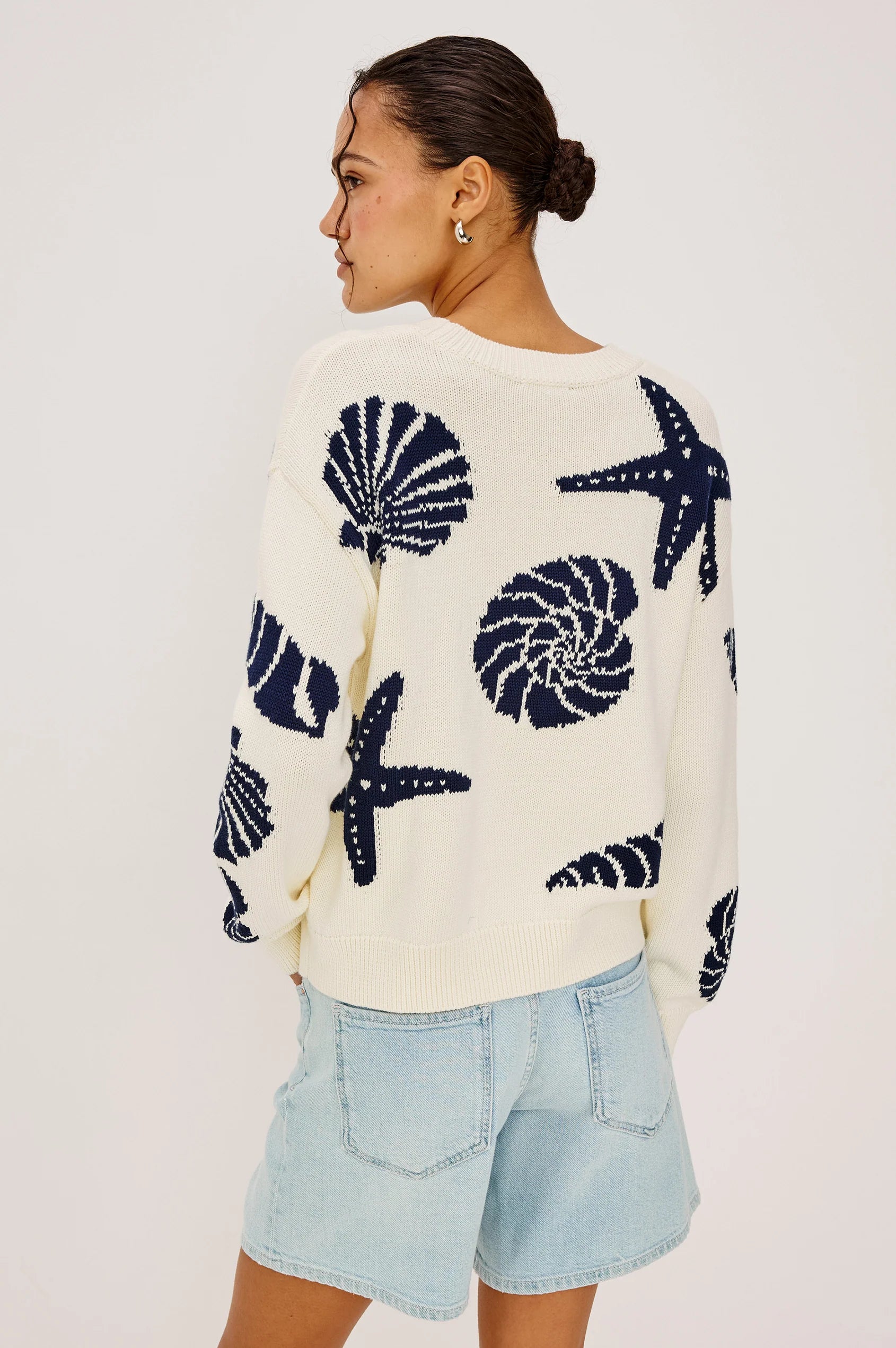 cream sweater with blue seashells all over