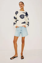 cream sweater with blue seashells all over