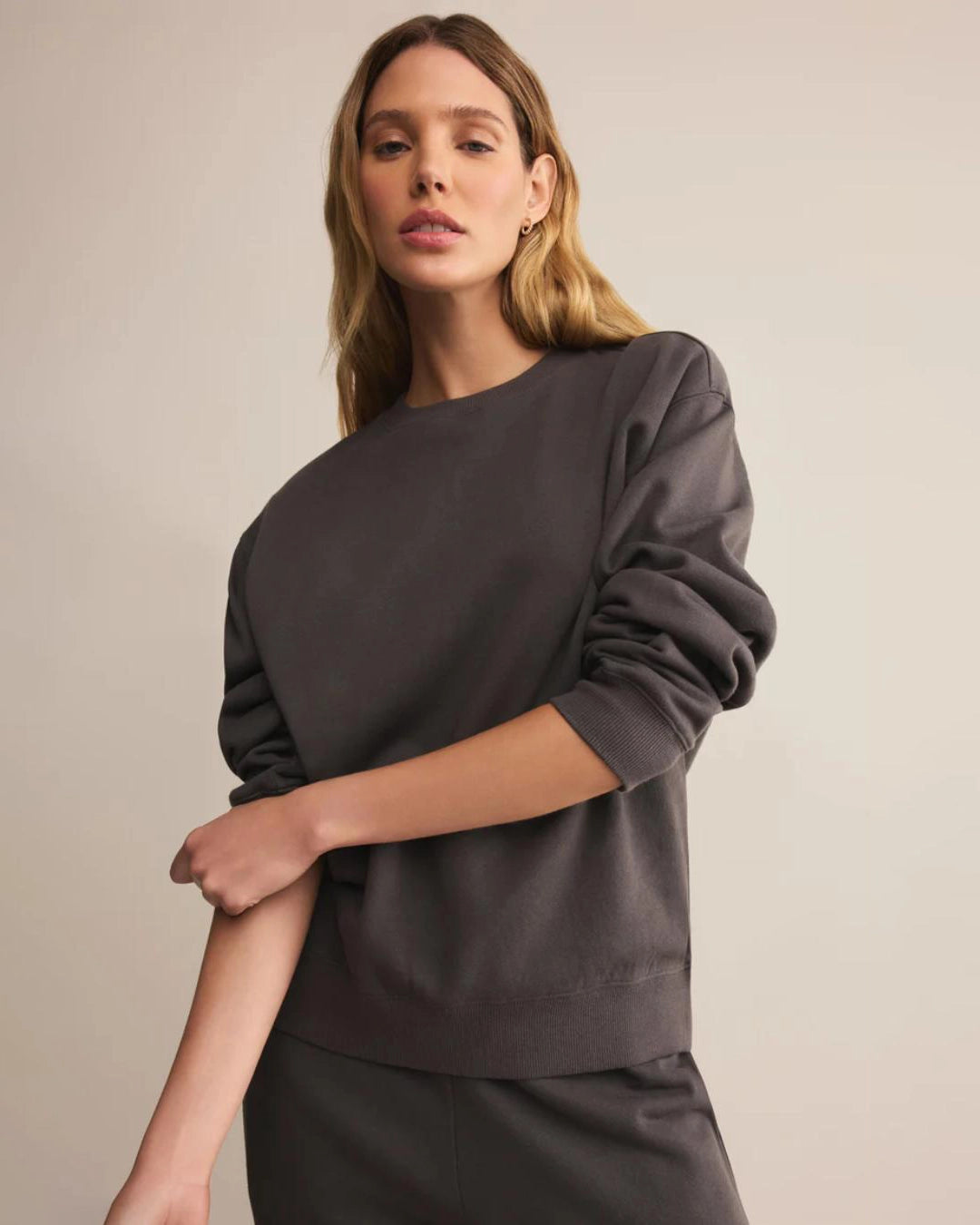 Woman wearing a dark gray cotton sweatshirt