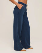 woman wears a blue drawstring denim pant by Z Supply