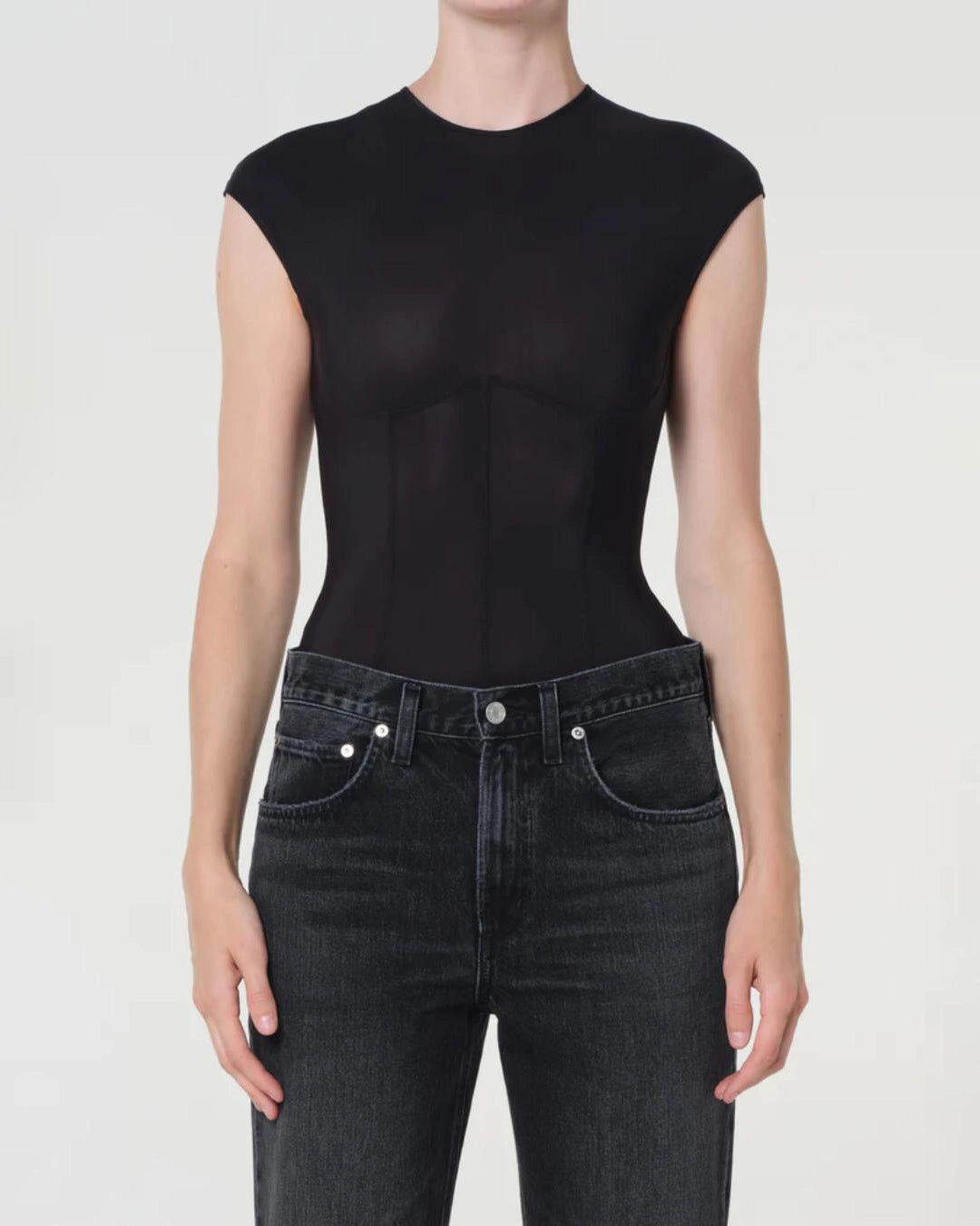 woman wearing a black bodysuit with a corset design by Agolde