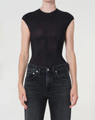 woman wearing a black bodysuit with a corset design by Agolde