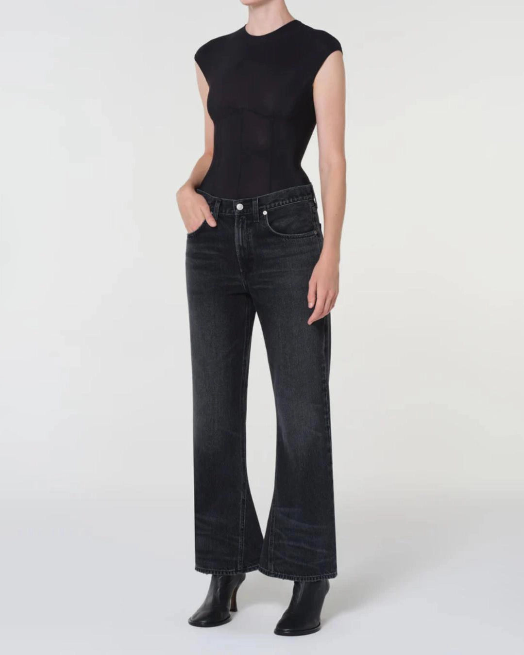 woman wearing a black bodysuit with a corset design by Agolde