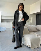 Woman wearing a dark gray  zip up knit jacket 