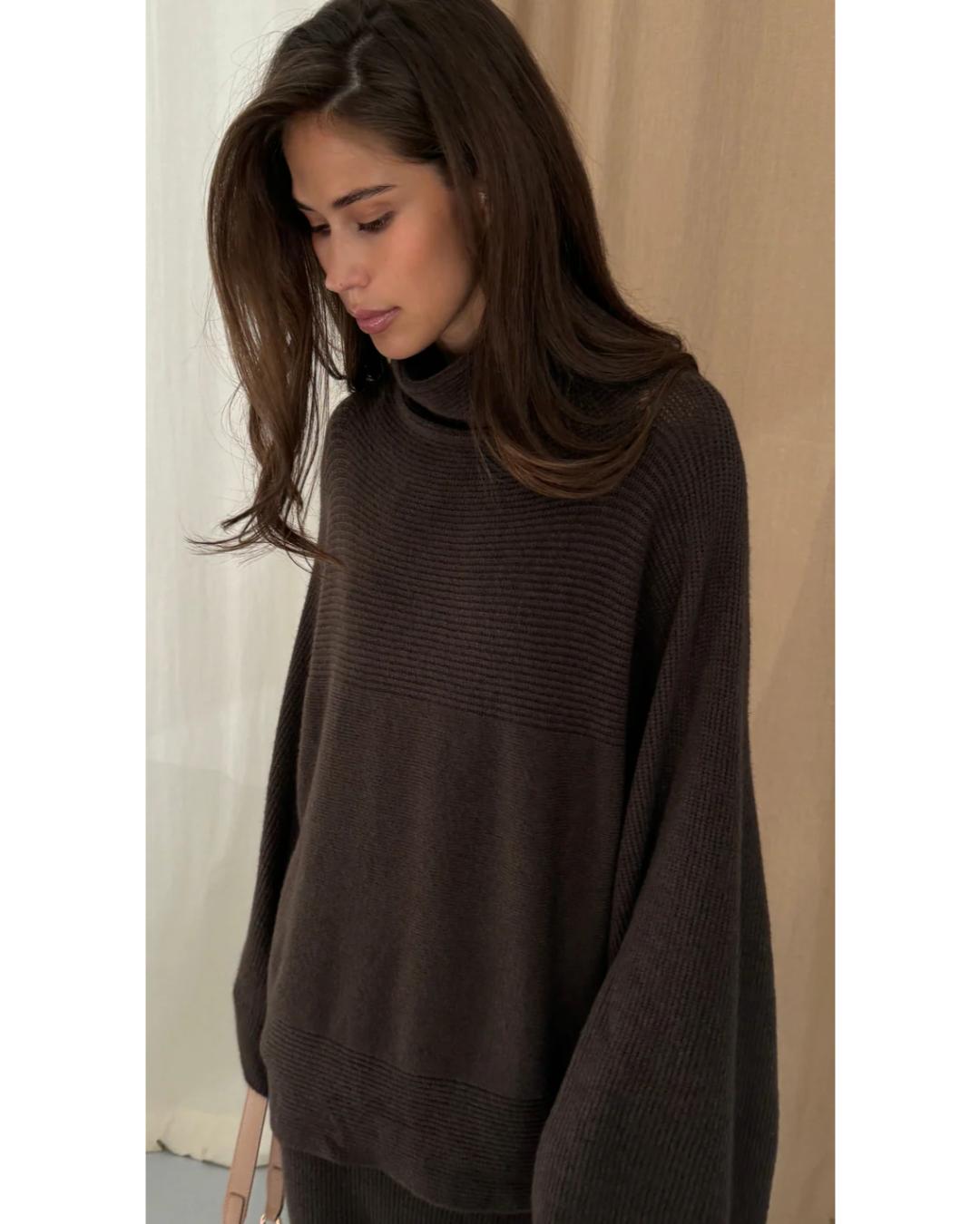 dark brown turtleneck sweater with an oversized look