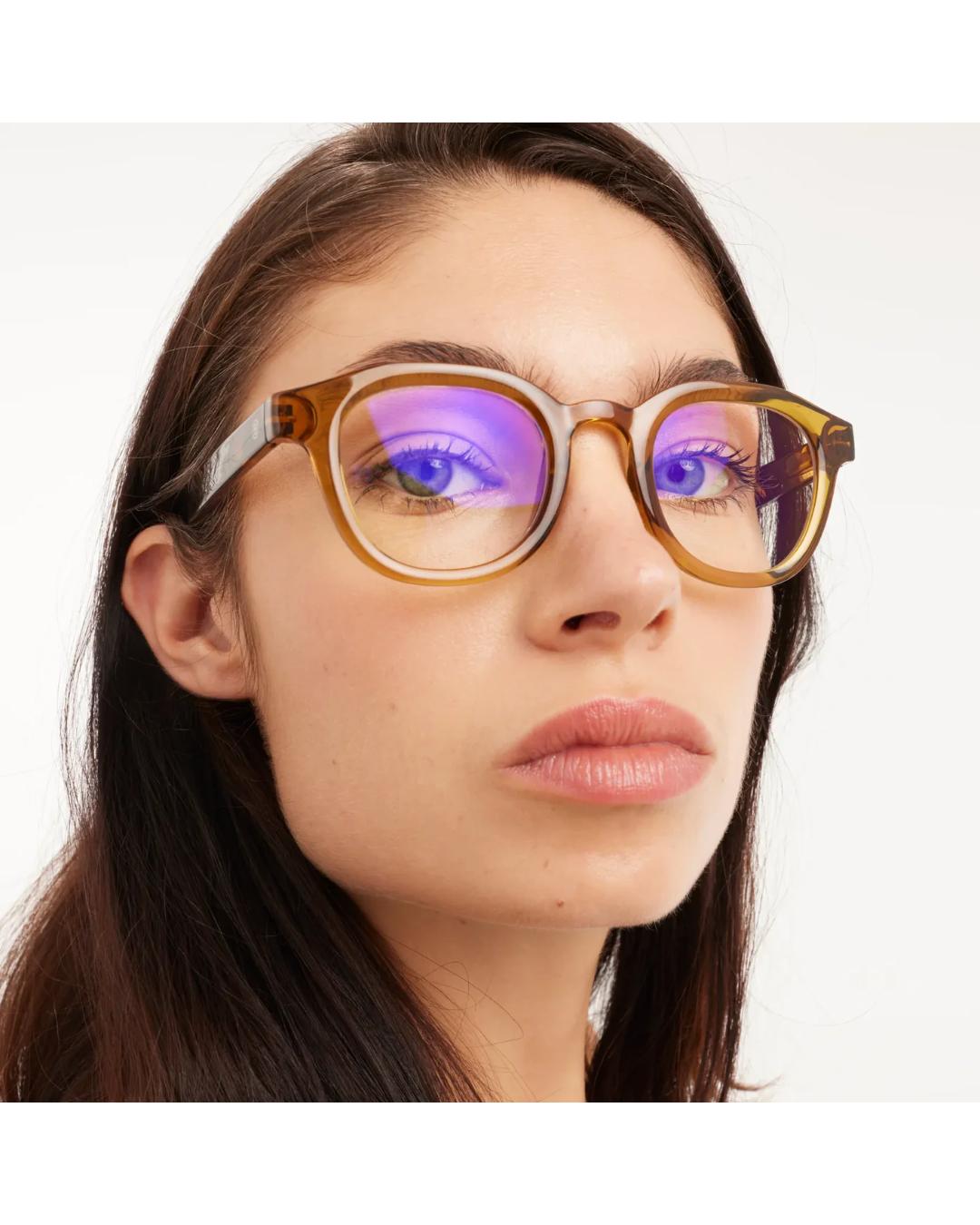 eyeglasses with a brown/olive frame and tortoise arms
