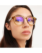 eyeglasses with a brown/olive frame and tortoise arms