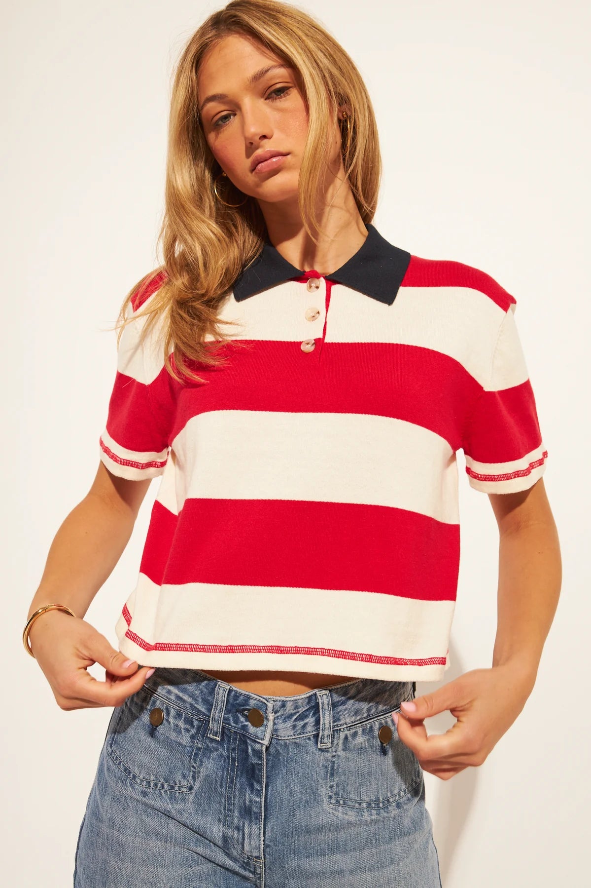 short sleeve polo shirt in cream and red stripes with a black collar 