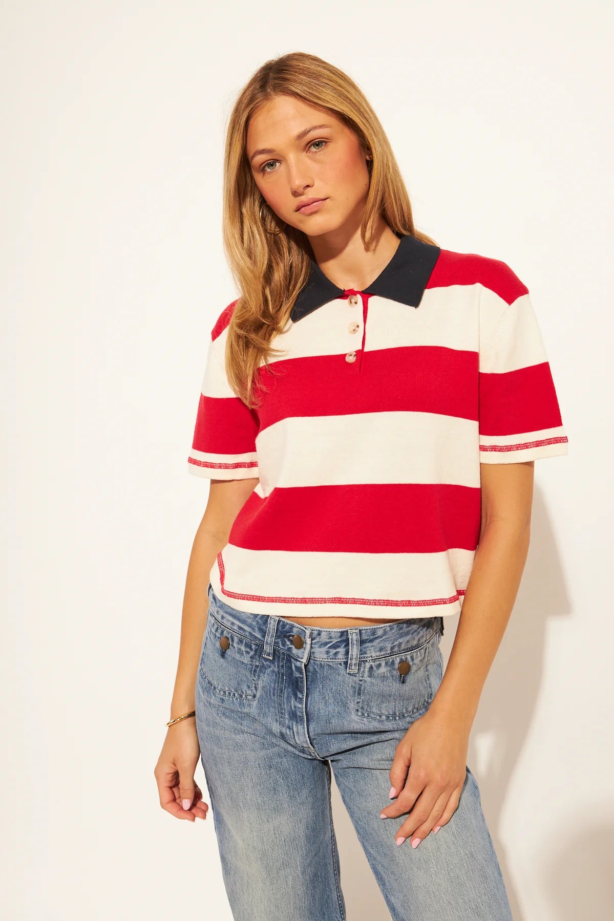 short sleeve polo shirt in cream and red stripes with a black collar 