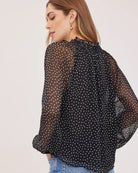 black blouse with white polka dots