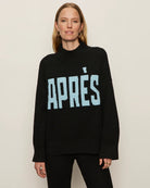 Woman wearing a black sweater with 'Après' text in light blue