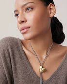 string tie necklace with a gold heart pendant