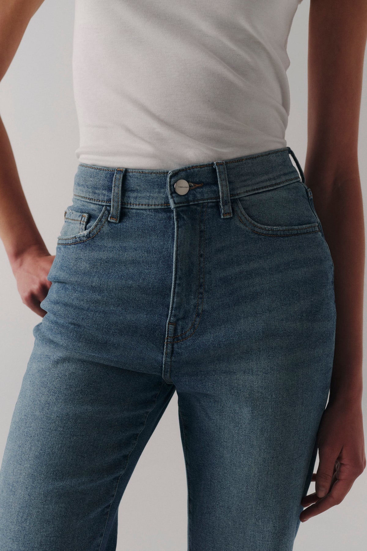 high rise straight denim pant with a medium wash