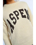 cream sweater with aspen written on the front