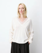 cream knit v-neck sweater with lace trim around neck