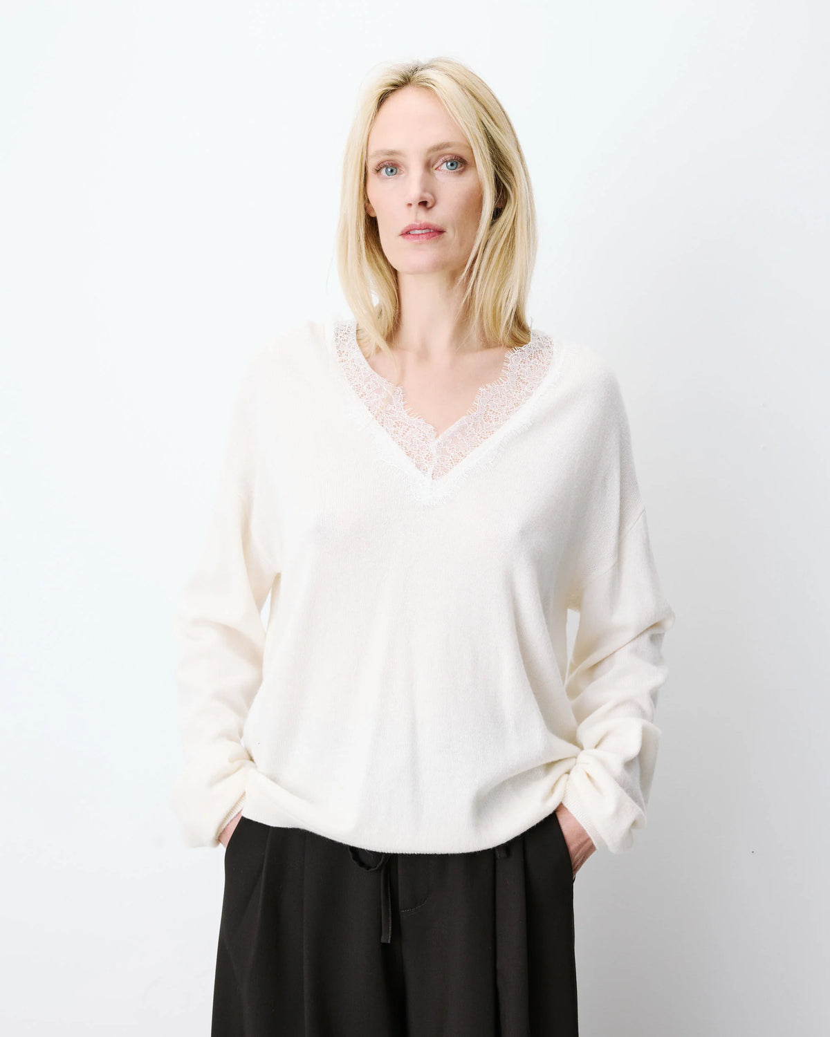 cream knit v-neck sweater with lace trim around neck