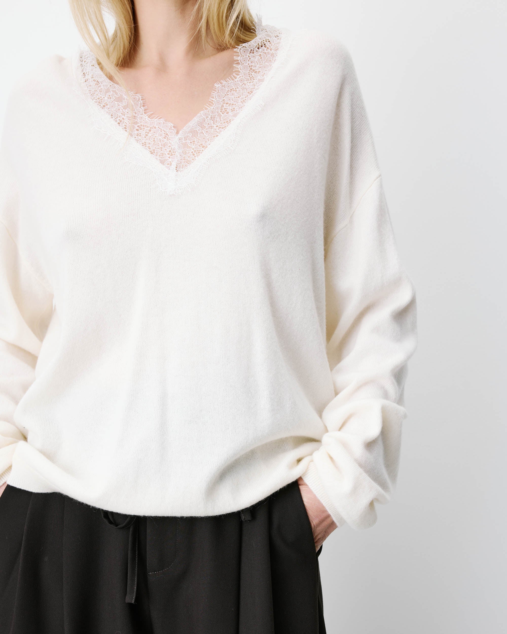 cream knit v-neck sweater with lace trim around neck