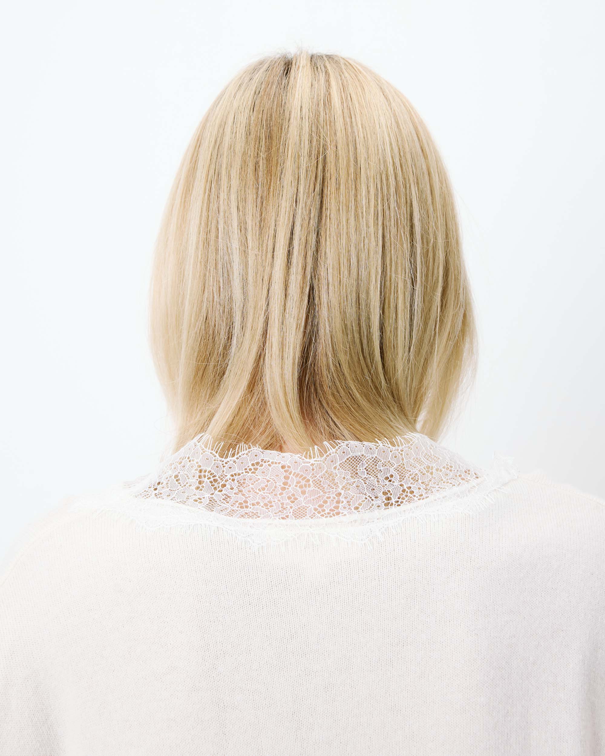 cream knit v-neck sweater with lace trim around neck