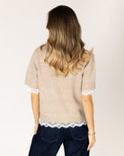 short sleeve knit top in beige with lace detail on bottom and sleeves