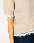 short sleeve knit top in beige with lace detail on bottom and sleeves