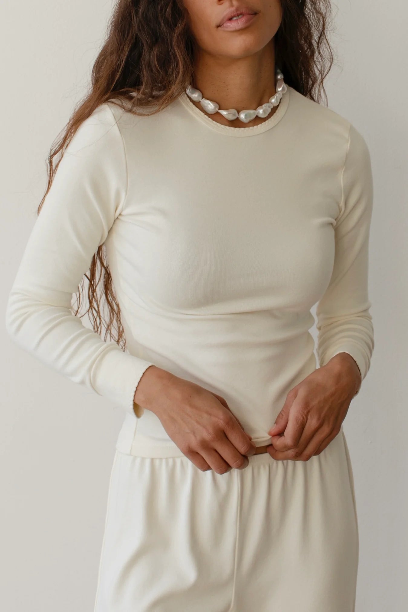long sleeve top in cream with scalloped edges